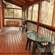 Back deck with patio table and chairs in cabin 101 (Heavenly Hideaway) at Eagles Ridge Resort at Pigeon Forge, Tennessee.