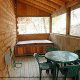 Large front porch with hot tub in cabin 235 (Romantic Retreat , in Pigeon Forge, Tennessee.