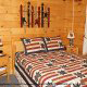 Country bedroom in cabin 312 (Bear Mountain Memories) at Eagles Ridge Resort at Pigeon Forge, Tennessee.