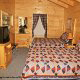 Country bedroom in cabin 312 (Bear Mountain Memories) at Eagles Ridge Resort at Pigeon Forge, Tennessee.