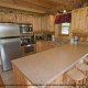 Country kitchen with bar in cabin 807 (Blackbeary Ridge) at Eagles Ridge Resort at Pigeon Forge, Tennessee.